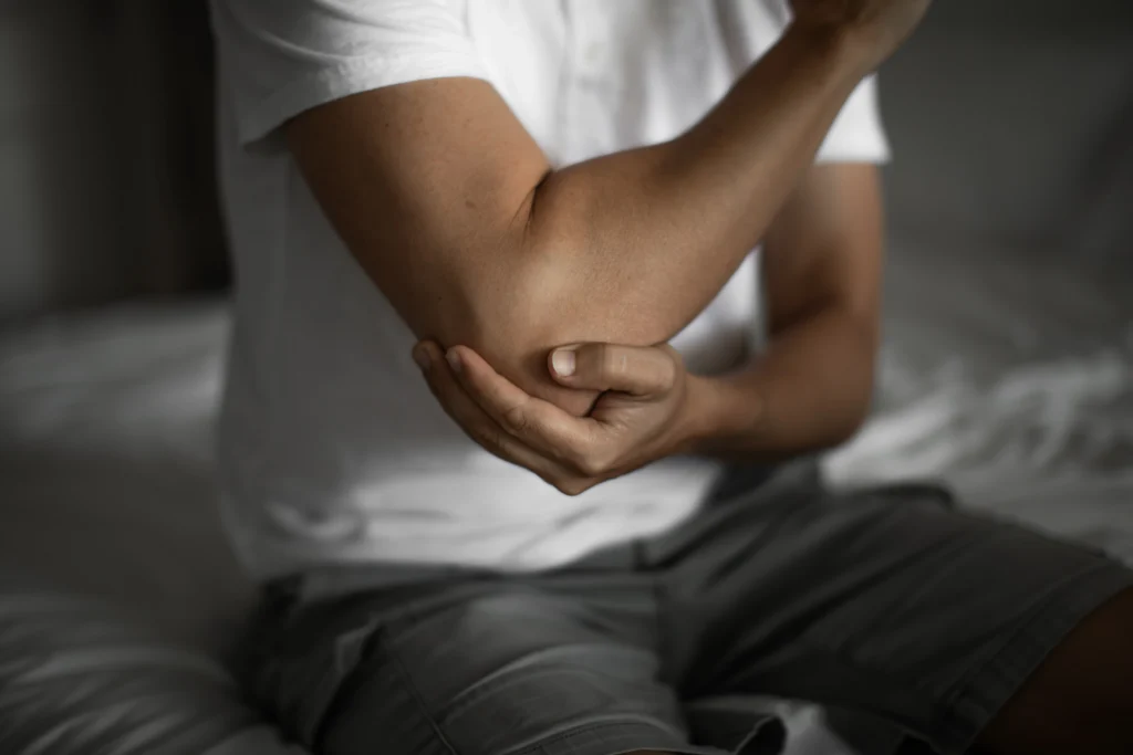 patient exploring the causes and treatment options for elbow bursitis.
