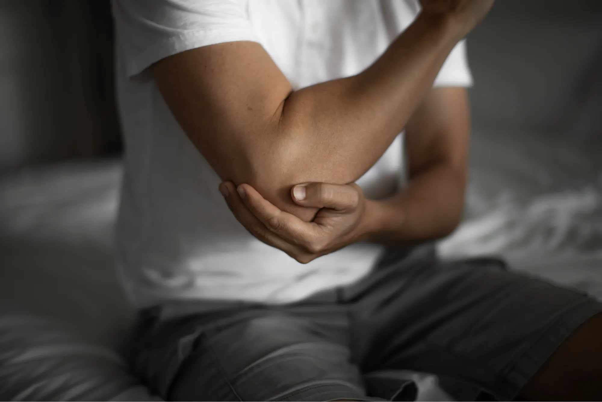 patient exploring the causes and treatment options for elbow bursitis.